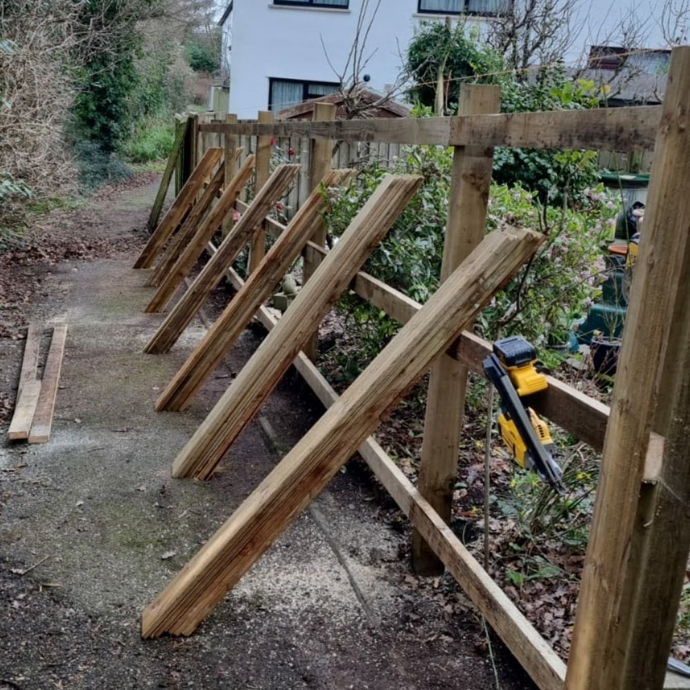 Posts fixed, rails ready and featheredge boards stacked